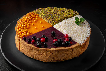 Classic gentle cheesecake of quarters: sea buckthorn, berry, coconut and pistachio. Chic dessert.