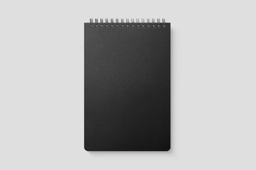 Real photo, spiral bound notepad mockup template with black paper cover, isolated on light grey background. High resolution.