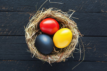 happy Easter card in german, Easter eggs are in germany flag color in nest