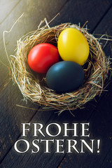 happy Easter card in german, Easter eggs are in germany flag color in nest