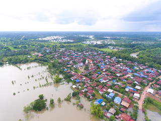 Sakonnakhon, Thailand - August 3, 2017 (Ban kang tha lap village,Kusumal district,Sakonnakhon) : Flood waters overtake a house and rice field in northeast of Thailand from above view by drone