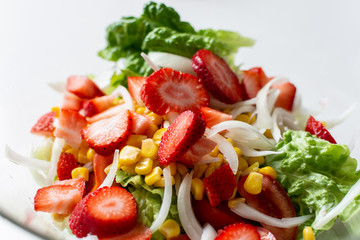 Bowl with delicious vegetable salad on white background