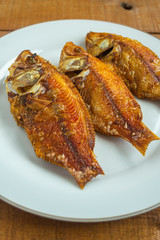 Ikan goreng or fried fish, 
has a good taste and has good nutrition for the body. on white plate