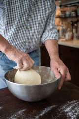 Fototapeta premium male hands making bread in kitchen at home