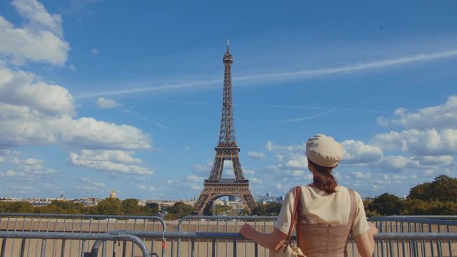 Young woman at the Eiffel Tower in Paris, France