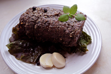 Beef and beef meat in a glass plate. Roast beef in spices. Cooking meat marinating in spices and herbs