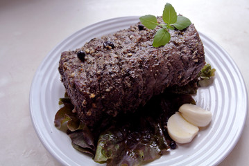 Beef and beef meat in a glass plate. Roast beef in spices. Cooking meat marinating in spices and herbs