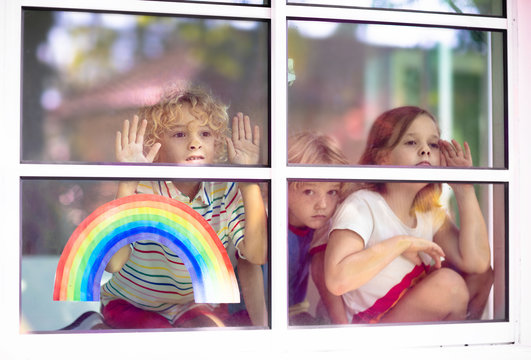 Coronavirus quarantine. Kids at window. Stay home.