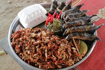Plate of grilled crabs and fishes sold in a cambodian food market