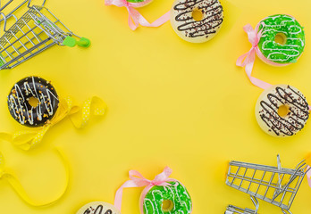 donuts and shopping cards on a yellow background and space for text.