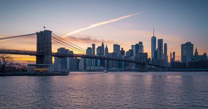 Panoramic Sunset View of Brooklyn bridge downtown Manhattan and one world seen from BUMBO day to night time lapse. New York city, NY, USA.