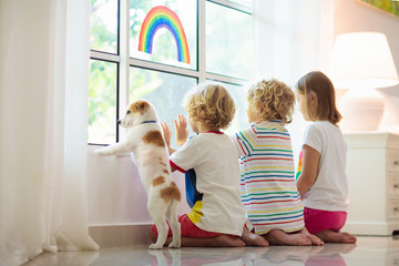 Coronavirus quarantine. Kids at window. Stay home.