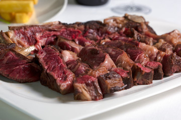 Medium, medium rare grilled steak in a plate. Grilled steak.