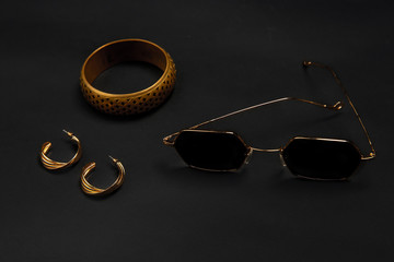 Accessories. Nailfile, eyewear, chain. Monochrome stylish and trendy composition in black and gold...