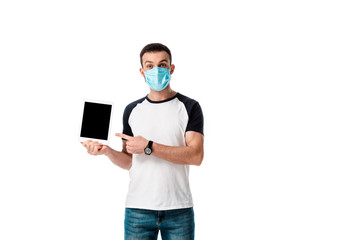 man in medical mask pointing with finger at digital tablet with blank screen isolated on white