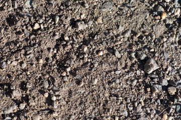 Coarse gravel, pebbles and sand are black, multicolor. Background texture closeup