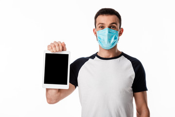 man in blue medical mask holding digital tablet with blank screen isolated on white