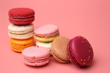 Colorful french macaroons on pink background