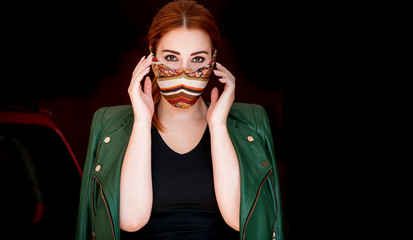 Young woman in fashionable homemade mask, scarf on her face, stop virus, save yourself 