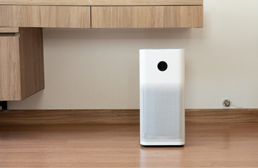 Indoor air purifier with digital monitor screen in bedroom, that show air quality in the room and air pollution levels in the room. PM 2.5 is a major environmental health problem affecting everyone.