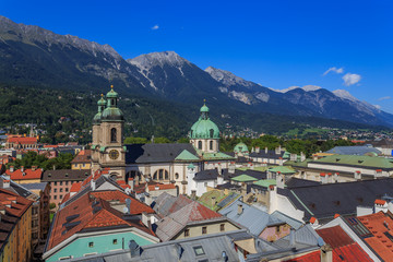 Naklejka na ściany i meble Bright and colorful eagle eye photo of the city center and its buildings of the Austrian Tirol city of Innsbruck, guided by its background alps.