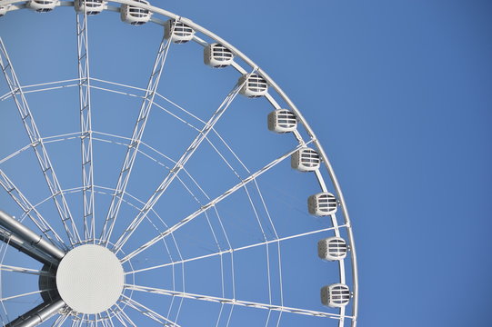 Ferris wheel against a clear blue sky