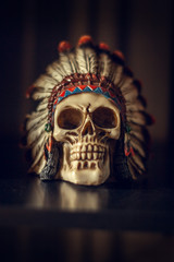 Closeup of a decorative indian skull on a tattoo studio.