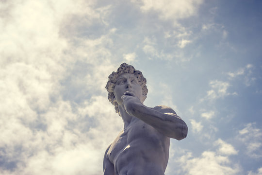 Public statue of Davi with clouds background.