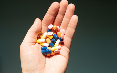Colorful pills and medicines in the hand.