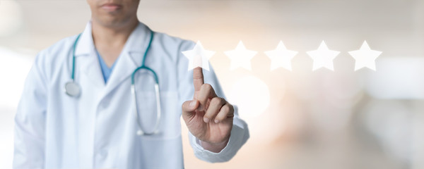Medical doctor with pointing finger on virtual screen with 5 stars sastisfaction rating and copy...