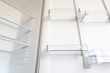 Fototapeta premium Empty shelves in refrigerator. The concept of diet and hunger