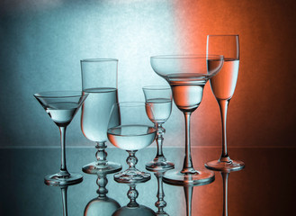 
Six glass goblets on color gradient background