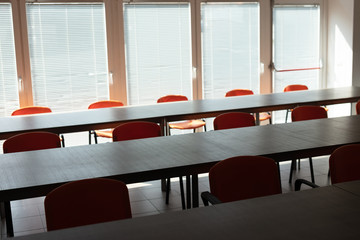 Empty desks and chairs in deserted office room