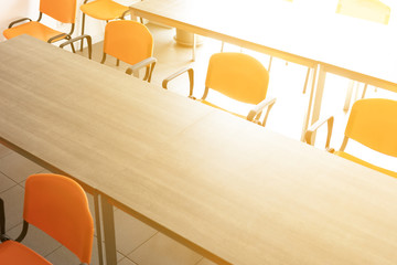 Bright empty conference room with desks and chairs