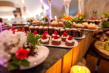 Delicious candy bar with macaroons, cupcakes and other sweets