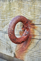 Rusty ring set in timber beam