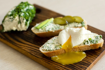 Rustic homemade cottage cheese with herbs, cream cheese. Sandwiches with homemade cheese, pickled cucumber, green onion and egg. Top view, side view, text space