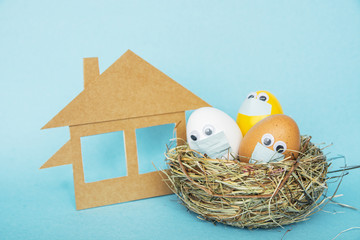 Stay Home at Easter holiday, Easter colored eggs in face mask and house  quarantine concept of...