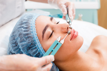 A woman on the procedure of injections in a cosmetology clinic