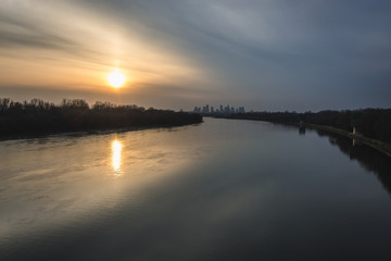 Fototapeta premium Sunset over River Vistula and distance view of downtown in Warsaw, Poland