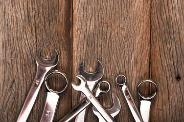 wrenches on wooden background