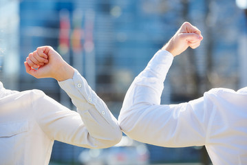 A close-up photo of elbow bumping. Elbow greeting to avoid the spread of coronavirus (COVID-19)....