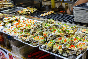 Chinese street food. Street trading. Chinese kinds of fresh seafood at an asian seafood market in Sanya, Hainan province, China. Inscription: name food.