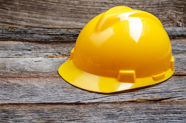 yellow Safety helmet on wooden background