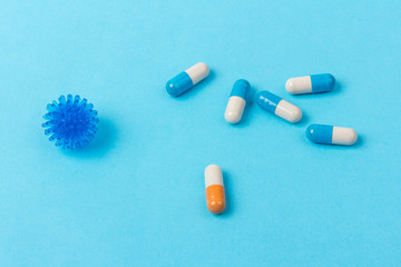 Pills isolated on blue background.Colorful medical drug capsule. Concept of coronavirus