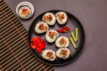Korean roll Gimbap(kimbob). Steamed white rice (bap) and various other ingredients. Trendy black background