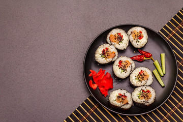 Korean roll Gimbap(kimbob). Steamed white rice (bap) and various other ingredients. Trendy black background