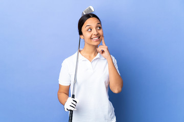 Young golfer woman over isolated colorful background thinking an idea while looking up