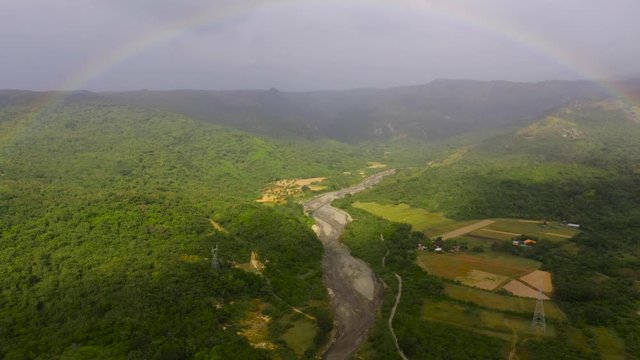 Mountain landscape with a rainbow on the island of Luzon, aerial view.
