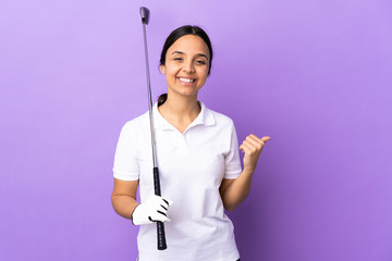Young golfer woman over isolated colorful background pointing to the side to present a product